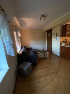 a living room with a couch and a table at Pieczarki in Pieczarki