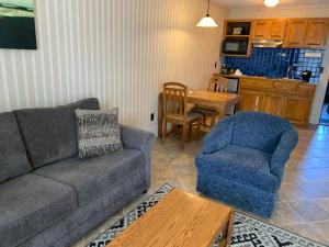 a living room with a couch and a chair and a table at Coachman Inn Oak Harbor in Oak Harbor