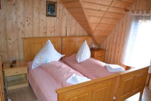 a bedroom with two beds in a log cabin at Pension Lucia Bucovina in Vama