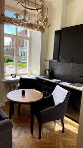 a kitchen with a table and two chairs and a table at Liepaja Center Theater Apartments in Liepāja
