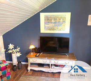 a living room with a television on a table at Haus Kierberg in Monschau