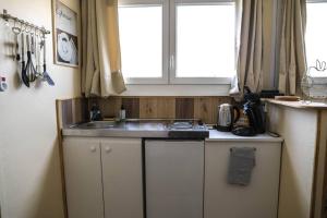 a kitchen with a sink and a window at Grand studio in Boulogne-sur-Mer