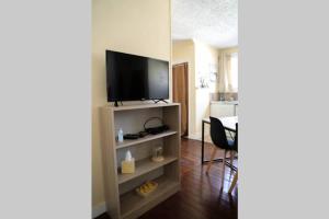 a living room with a flat screen tv on a shelf at Grand studio in Boulogne-sur-Mer +6 photos