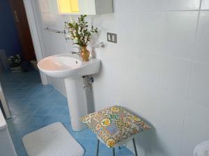 ein Badezimmer mit Waschbecken, Toilette und Hocker in der Unterkunft Le Lamie in Sessa Cilento + 47 Fotos
