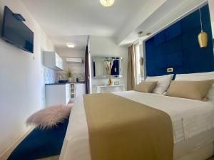 a bedroom with a large bed with a blue headboard at Luxury Studio apartment Marinovic in Makarska