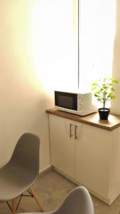 A television and/or entertainment centre at Helena Stúdió Apartman