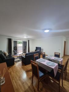 uma sala de estar com uma mesa e cadeiras e um sofá em Suncoast Residence V (Free parking) no Funchal