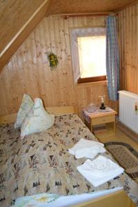 a bedroom with a bed and a window at Pension Lucia Bucovina in Vama