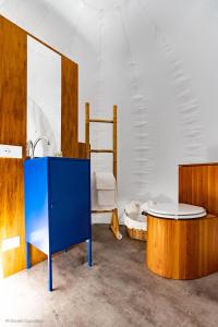 a blue cabinet and a table in a room at La Bolla del Borgo. Le Marche tra le stelle. in Corinaldo
