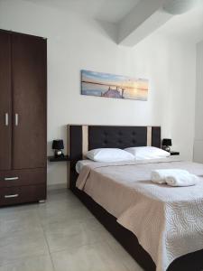 a bedroom with two beds and a painting on the wall at Sunny Siviri in Siviri