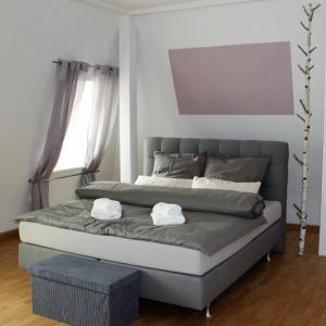 a bed with two towels on it in a bedroom at Villa Schlossblick in Wernigerode