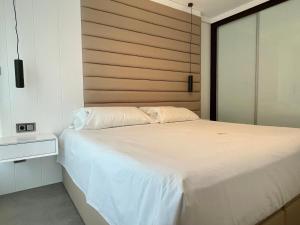 A bed or beds in a room at Luxury boutique playa Silgar