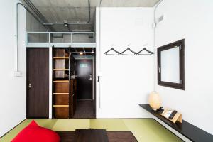 a living room with a red pillow and a table at Oyado danran 団欒 in Tokyo