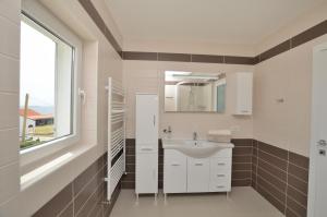 a bathroom with a sink and a window at Villa Sofia in Martinšćica +47 photos