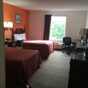 a hotel room with two beds and a window at President Inn & Suites in Gettysburg
