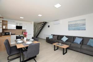 a living room with a couch and a table at Villa Sofia in Martinšćica