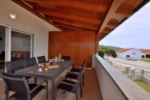 a dining table on the balcony of a house at Villa Sofia in Martinšćica