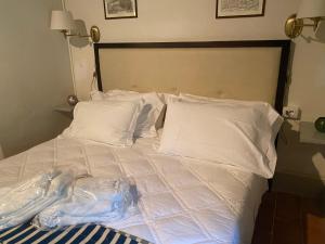 Postel nebo postele na pokoji v ubytování Albergo Le Casaline
