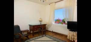a room with a desk and a window and a chair at Mirabella Vista in Agios Nikolaos