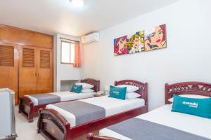 a room with two beds and a tv in it at Ayenda 1309 Villa Dilia in Barranquilla +20 photos