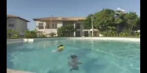 two people playing in a swimming pool at Imbassaí in Imbassai