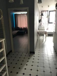 a room with a hallway with a table and chairs and a floor at Airport apartment in Saint Petersburg