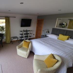 a large bedroom with a large bed with yellow pillows at Inverness House in Inverness