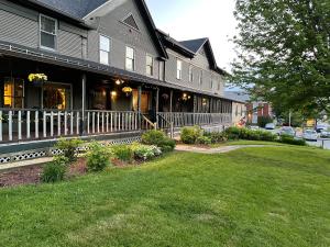 a house with a lawn in front of it at Smugglers Notch Inn in Jeffersonville
