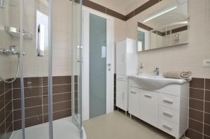 a bathroom with a shower and a sink at Apartments Villa Sofia in Martinšćica +82 photos