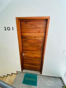 una puerta de madera con un cartel delante en Centrico Departamento 201 en Cancún