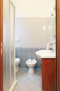 a bathroom with a toilet and a sink at Residence Hotel Gloria in Palermo