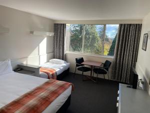 Postel nebo postele na pokoji v ubytování Parklane Motel