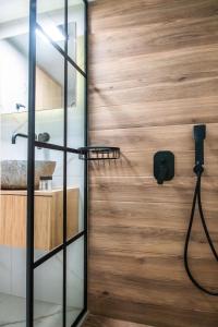 a pivot door in a bathroom with a shower at Luxury Seaside House in Mades Heraklion in Agia Pelagia +49 photos