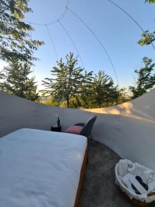 a bedroom with a bed and a chair on a balcony at La Bolla del Borgo. Le Marche tra le stelle. in Corinaldo