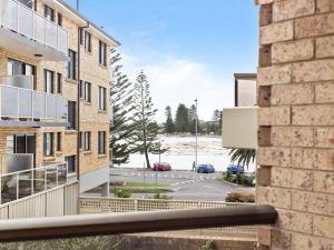 a view from the balcony of a building with a parking lot at Sundowner Apartment 5 in The Entrance