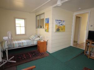 a room with a bed and a window and a television at North Haven Sea Breeze in North Haven
