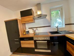 a kitchen with a sink and a stove at Apartment Stella in Bad Ischl