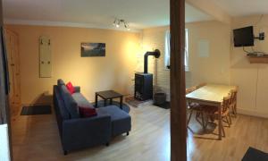 a living room with a couch and a table at Ferienwohnung Magdalena in Hohnstein