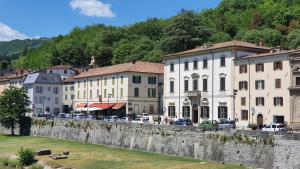 a group of buildings in a town next to a river at Ostello Antica Filanda in Santa Sofia