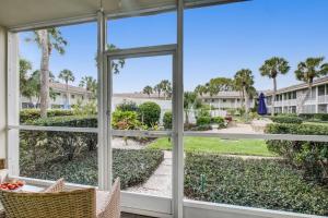 a room with a window looking out at a park at Kingston Arms 1st Floor in Sarasota +42 photos