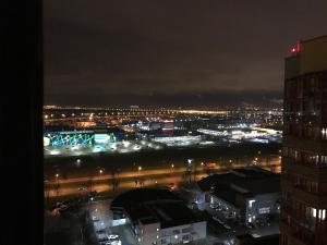 a view of a city at night with lights at Airport apartment in Saint Petersburg