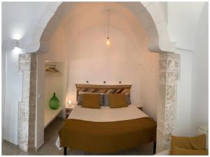 a bedroom with a large bed in a room at White Stone Flats & Studios in Ostuni