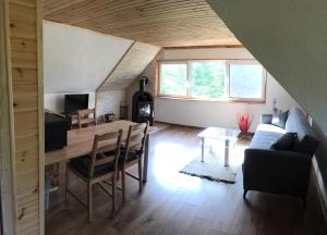 a living room with a table and a couch at Ferienwohnung Julia in Hohnstein