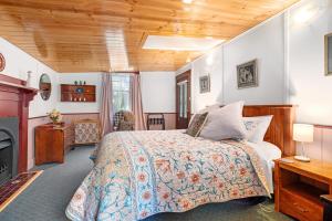 a bedroom with a bed and a fireplace at Hamlet Downs Country Accommodation in Fentonbury