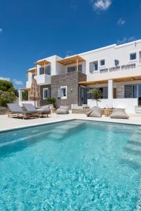 uma grande piscina em frente a uma casa em Drios Luxury Studios em Drios