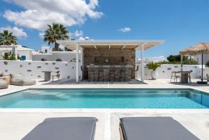 a villa with a swimming pool and a fireplace at Drios Luxury Studios in Drios