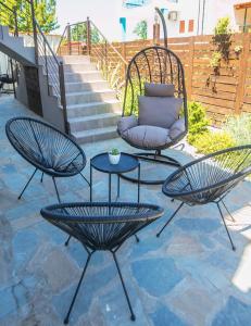 two chairs and a table on a patio at Sunny Siviri in Siviri +25 photos