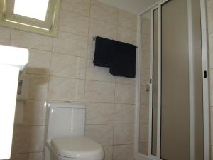 a bathroom with a toilet and a towel on the wall at Pensao Residencial Vila Teresinha in Funchal