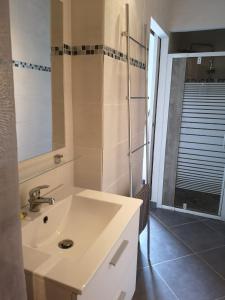 塞里尼昂的住宿－Plénitude，浴室设有白色水槽和镜子