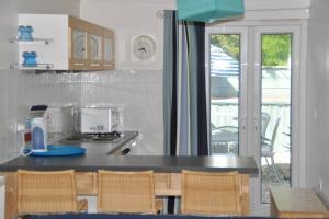 a kitchen with a counter with chairs and a window at Pembroke Townhouse in Pembrokeshire
